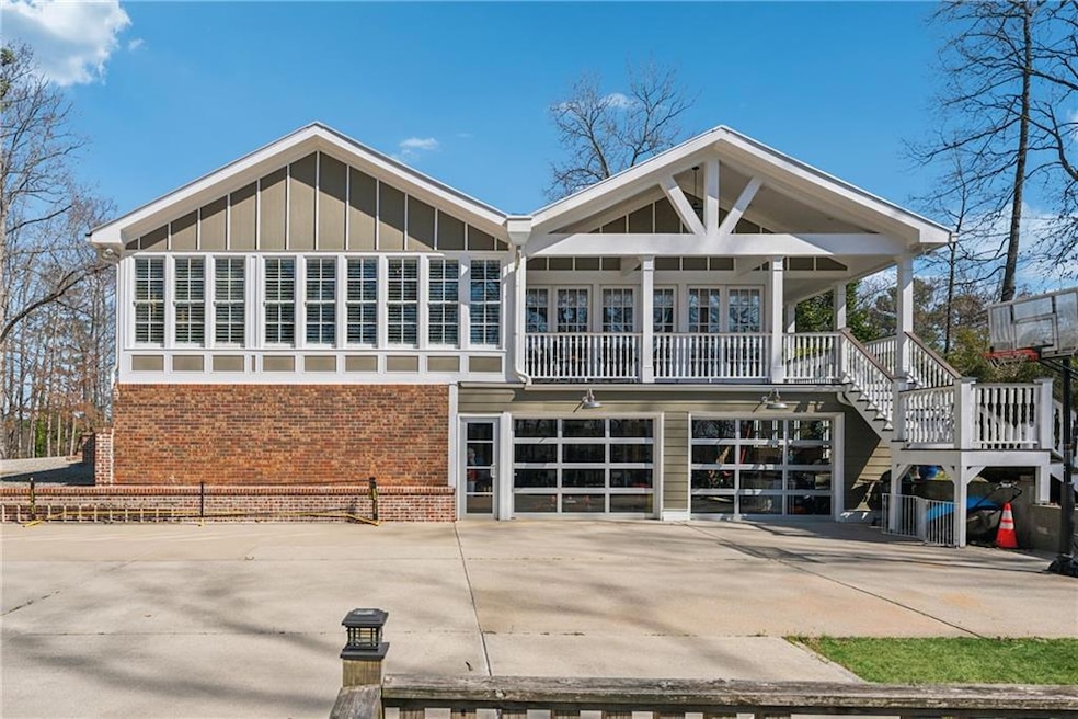 Back of house with a porch, brick siding, board an