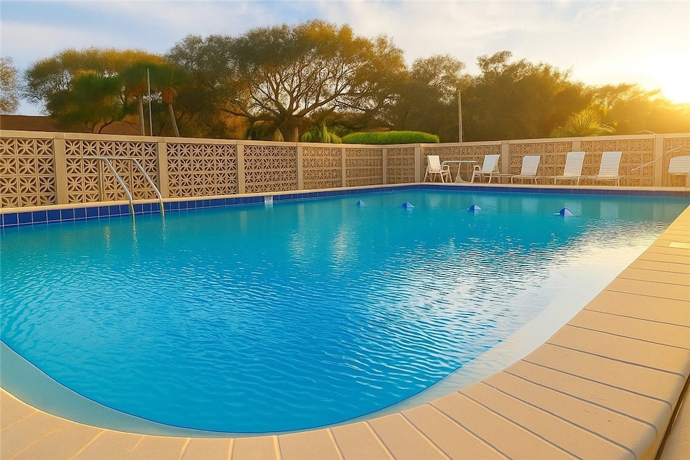 Pool at dusk with a community pool and a patio