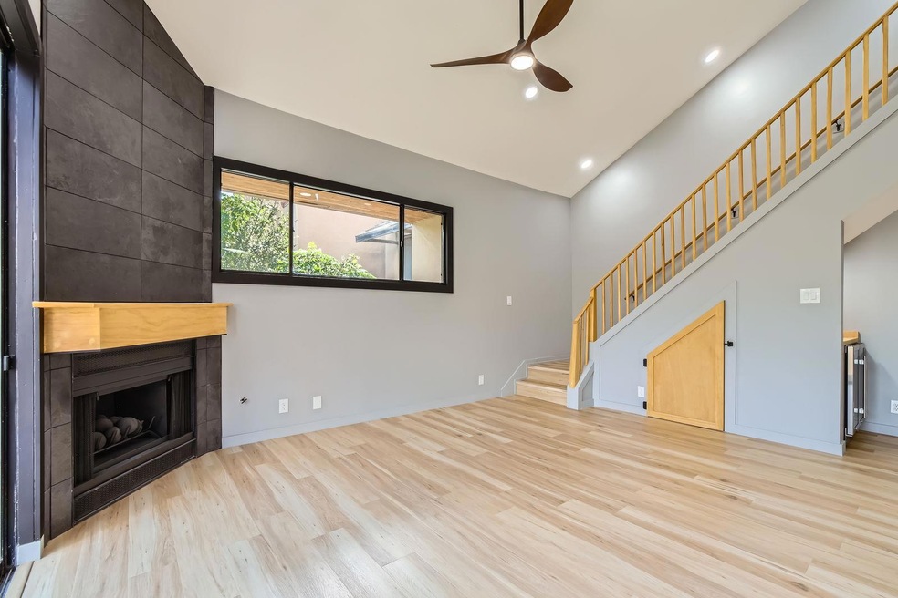 Unfurnished living room featuring a ceiling fan, 