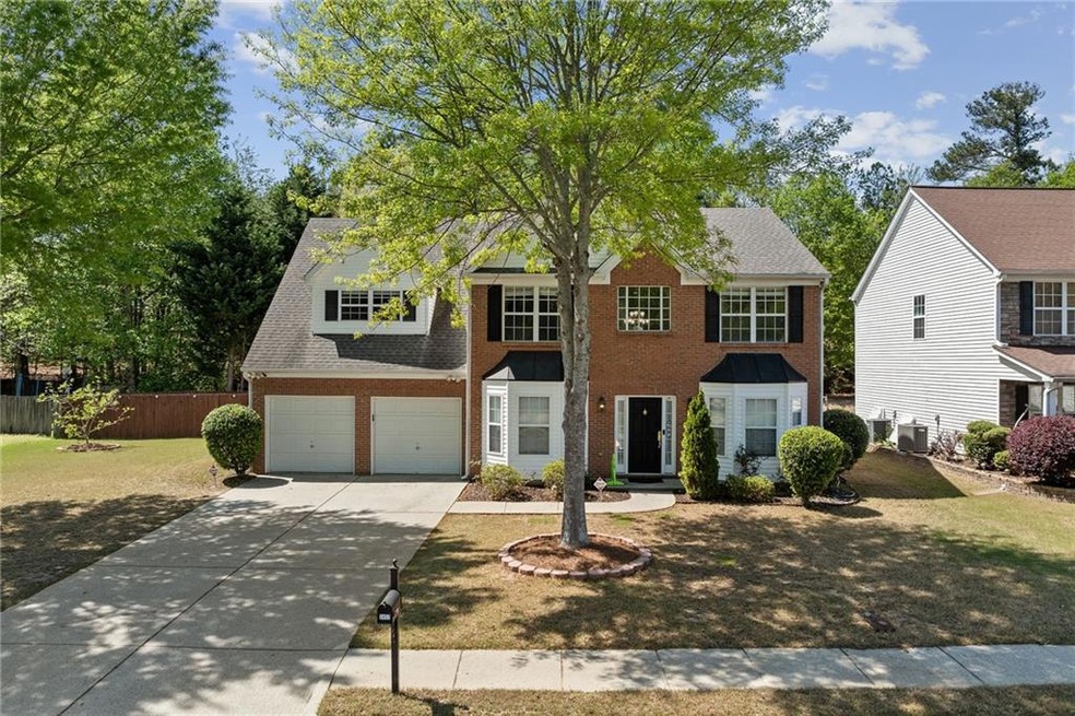 Colonial inspired home featuring driveway, cooling