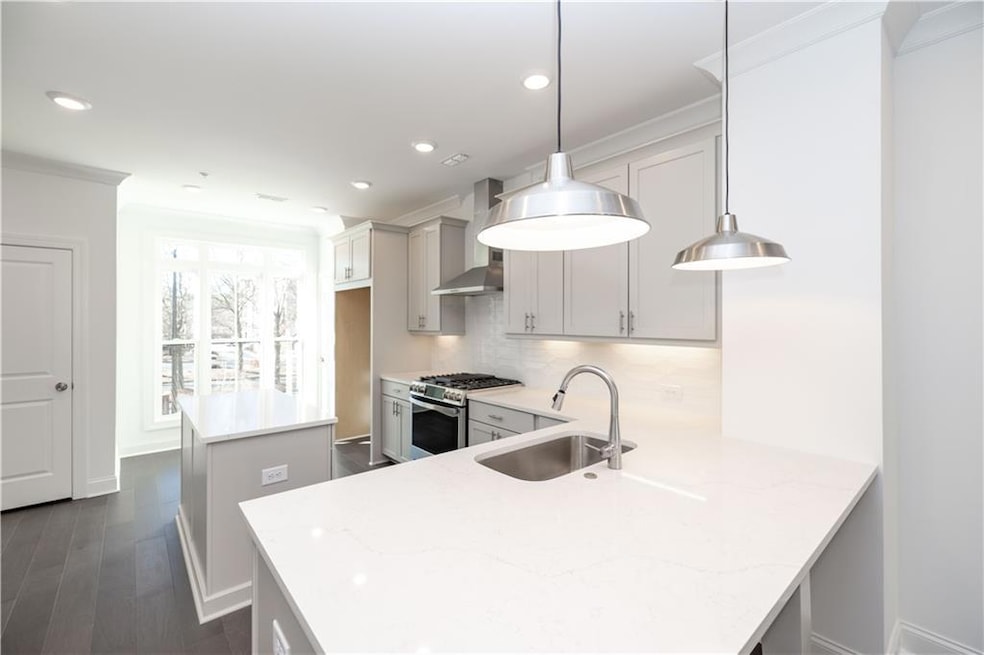 Welcome to Ecco Park - homesite 28 Barnsley plan featuring a stunning kitchen with pale gray cabinets and gorgeous quartz countertops!