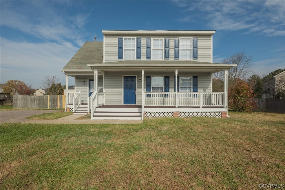View of front of house featuring a front lawn and covered porch