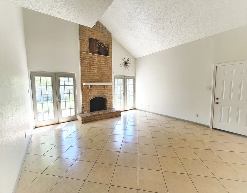 Natural lights shine through this vaulted tiled living area
