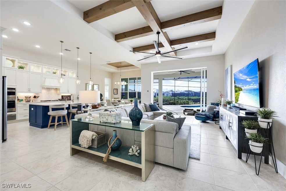 Living room featuring ceiling fan with notable cha