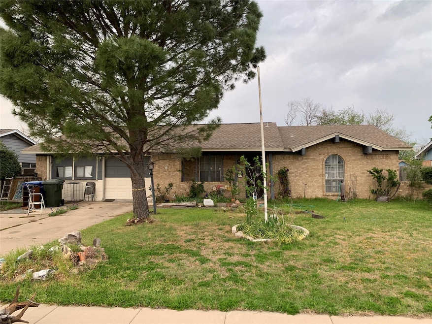 Single story home featuring driveway, a front yard