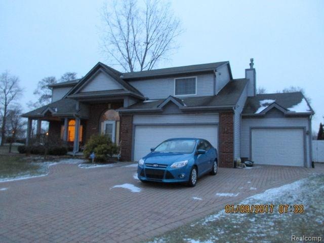 FRONT VIEW BRICK PAVERS, COVERED PORCH, 3 CAR GARA
