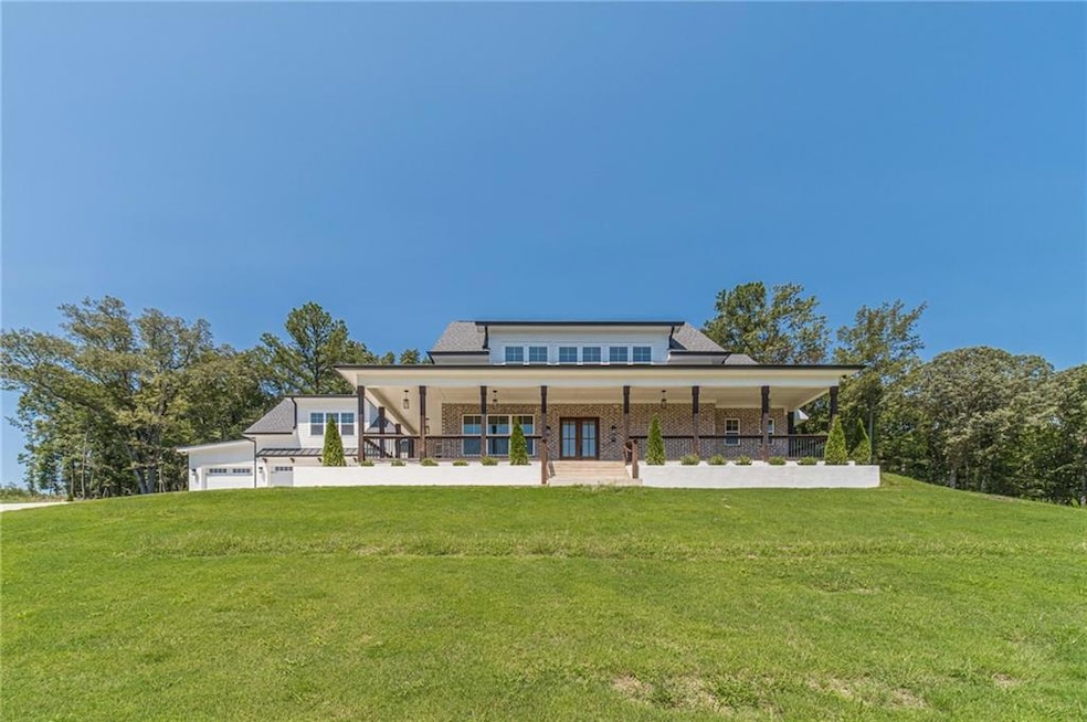 Back of house featuring a yard, a porch, and brick siding