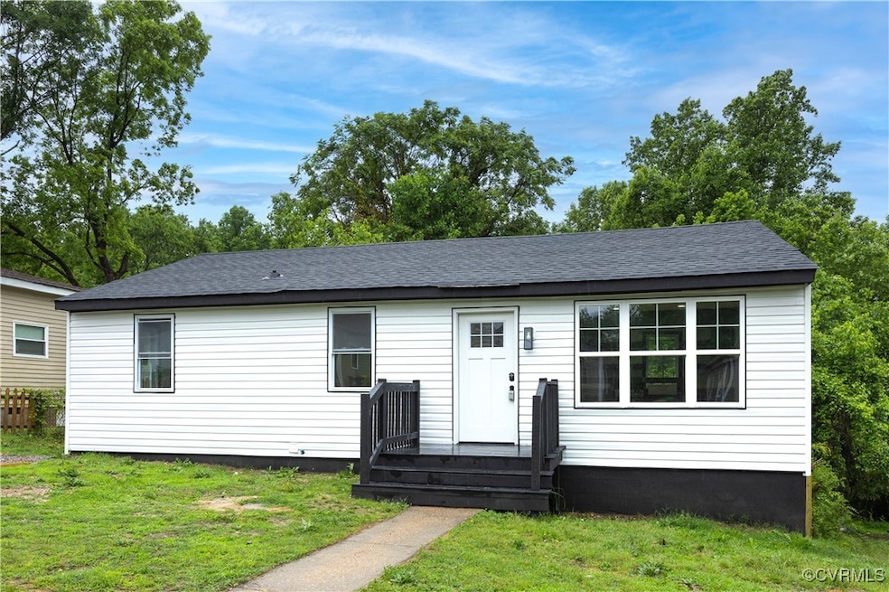 View of front of house with a front lawn and a shi