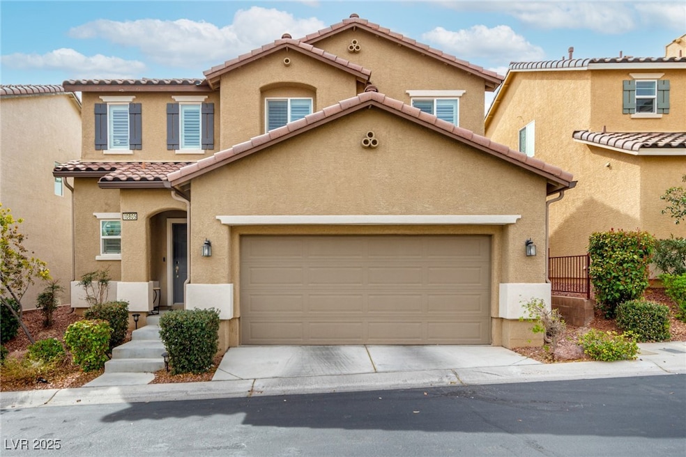View of front of house with a garage, a tile roof,