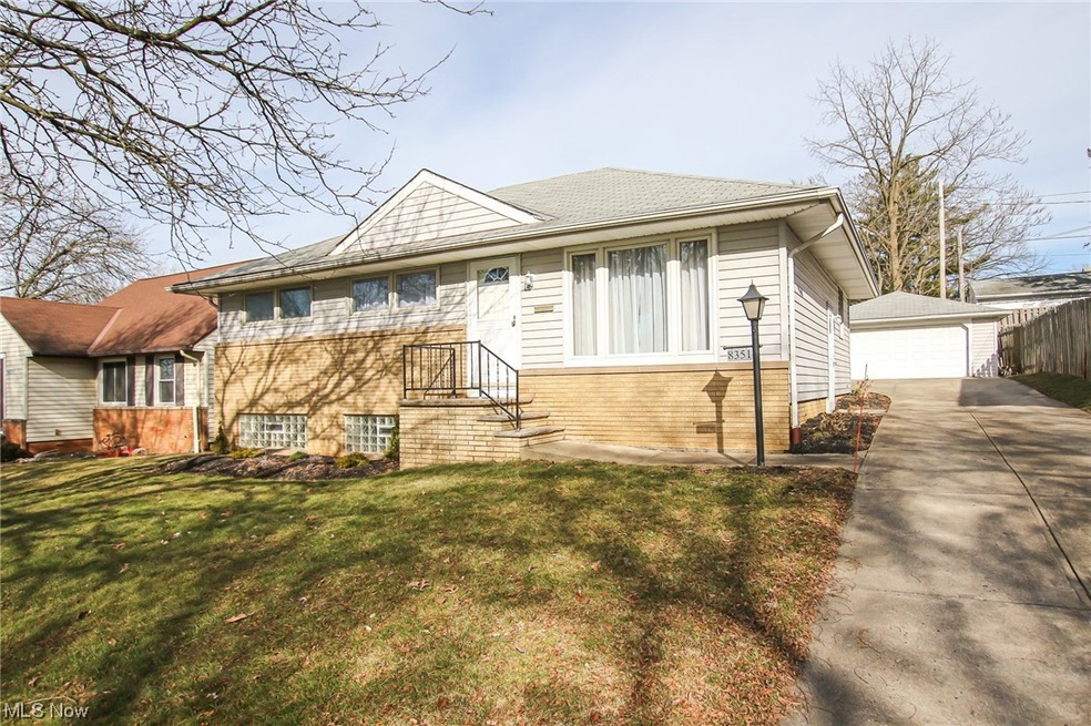 View of front of property with a front lawn and a garage