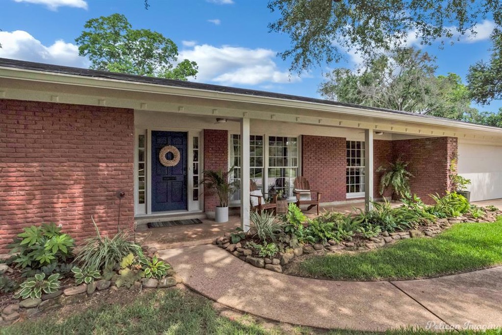 Landscaped flower beds and covered front porch.