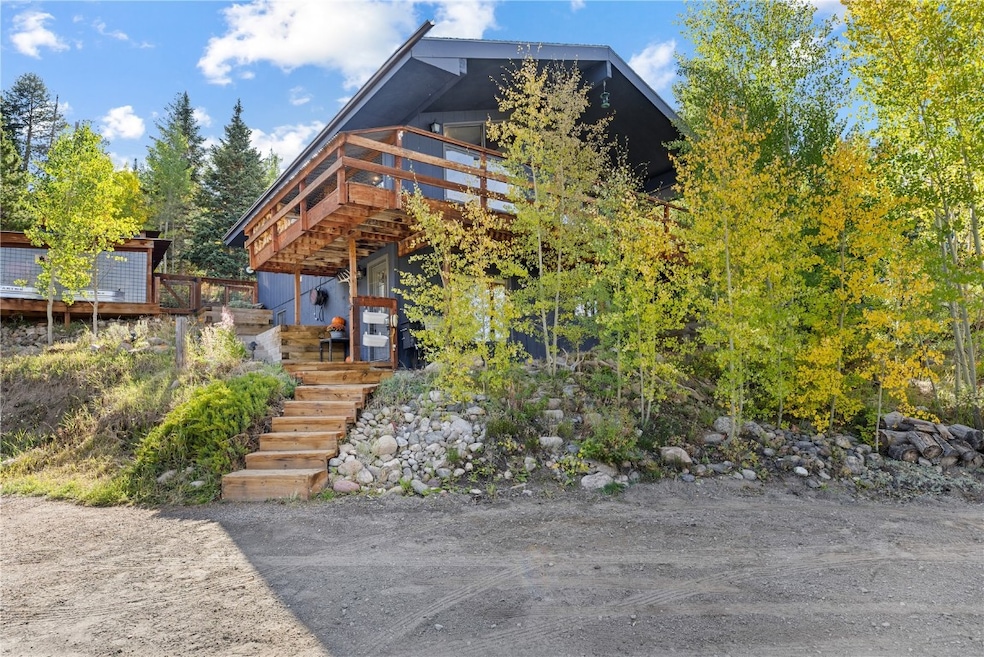 View of front of home with a deck and stairs