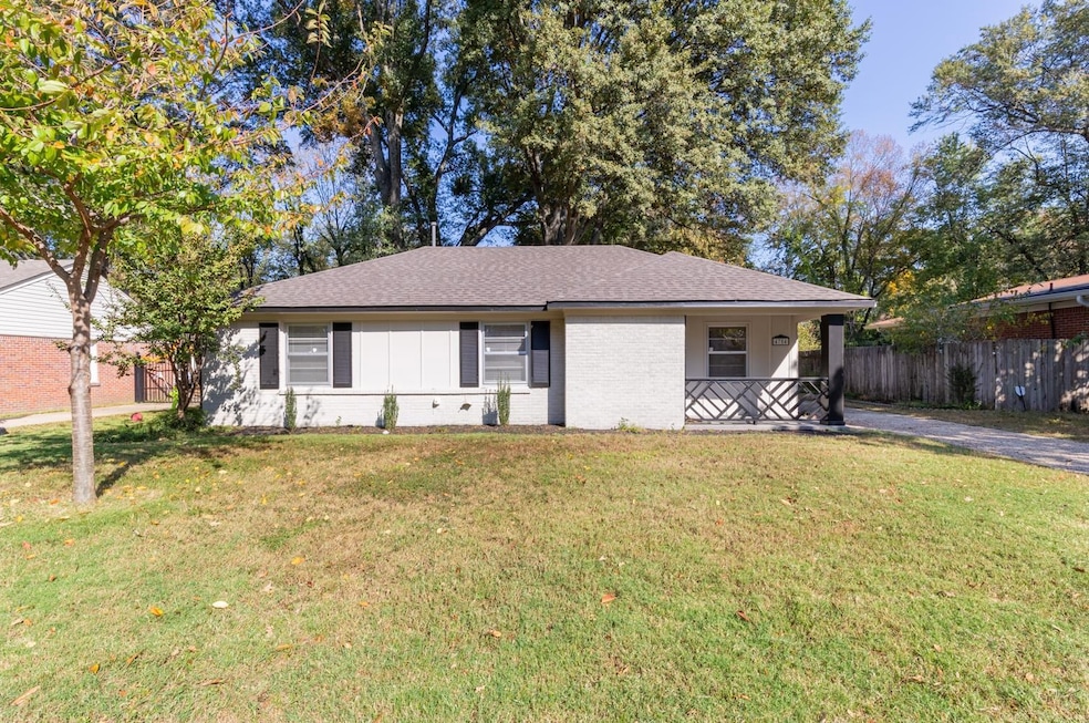 Ranch-style home featuring a front lawn