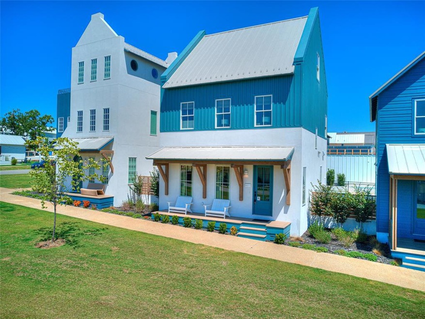 View of front of house with a porch and a front ya