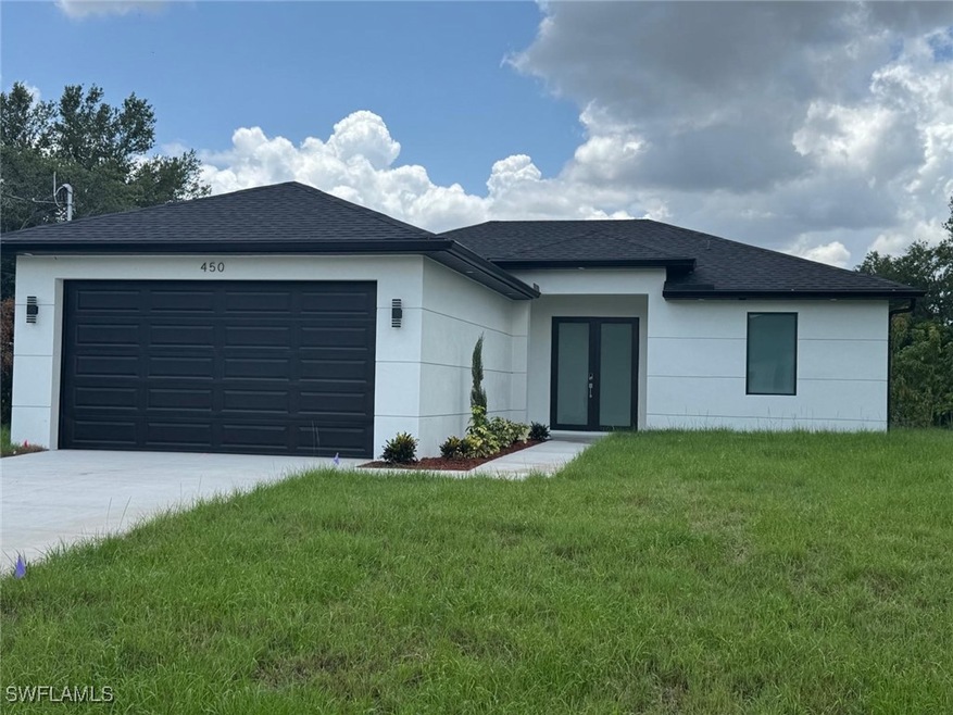 View of front of house with french doors, concrete