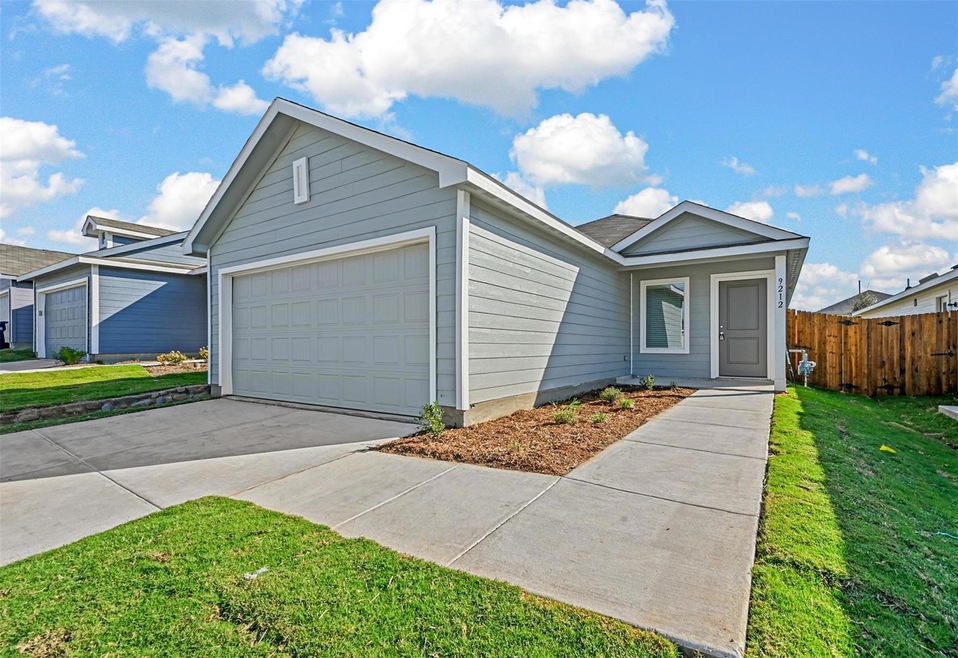 Ranch-style house featuring a garage and a front l