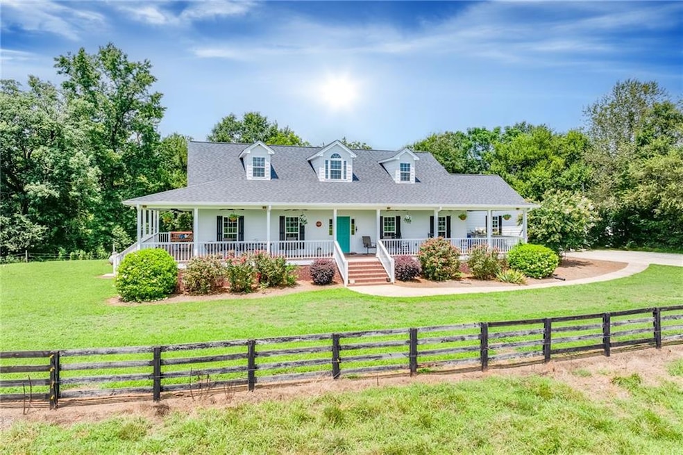 Cape cod house with covered porch andafront yard