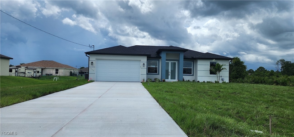 View of front facade with concrete driveway, an at