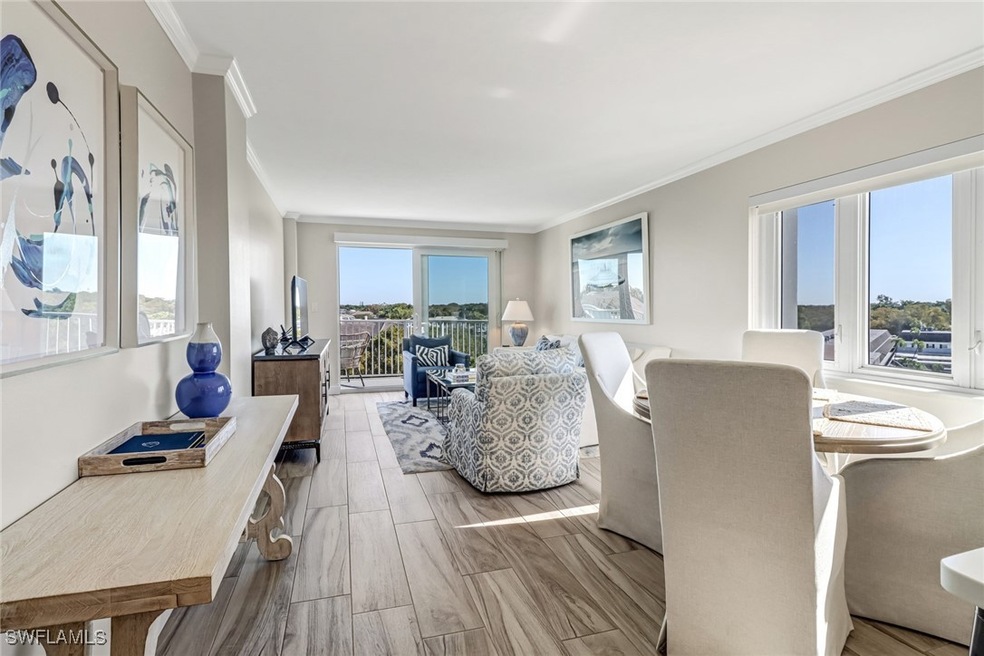 Living room with light wood-type flooring and orna