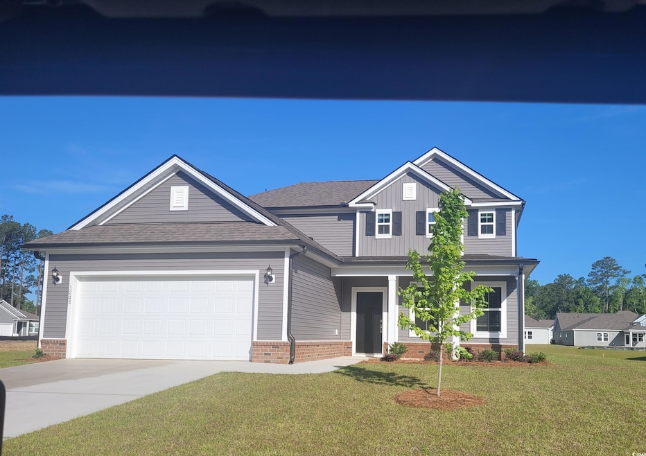 View of front facade featuring driveway, a garage,