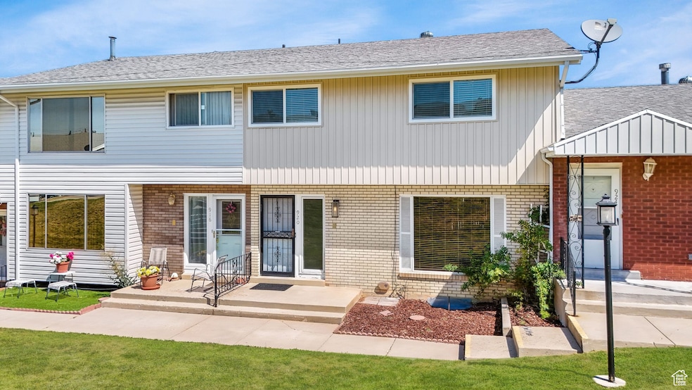 View of front of house featuring brick siding and roof with shingles
