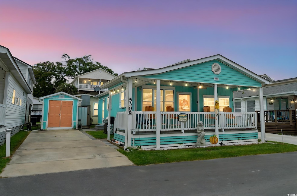 View of front facade featuring a storage shed and covered porch