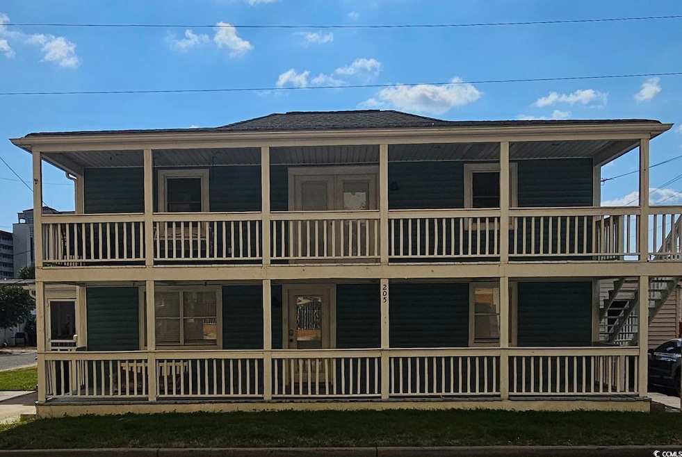View of front of home with roof with shingles