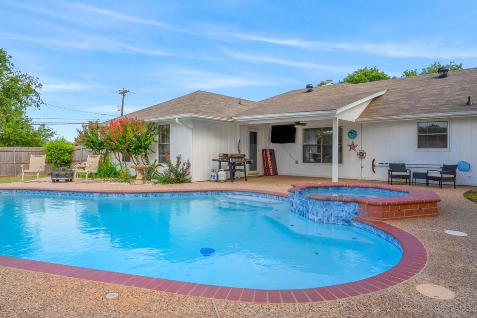 View of swimming pool with a patio area, an in gro