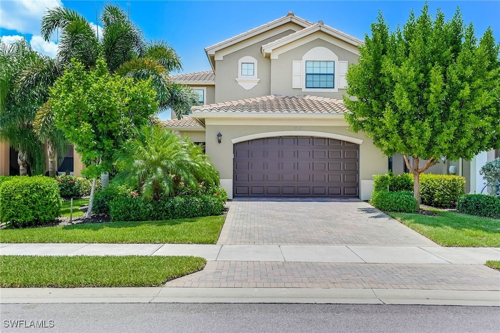 Mediterranean / spanish-style house with decorative driveway, stucco siding, a garage, and a tiled roof