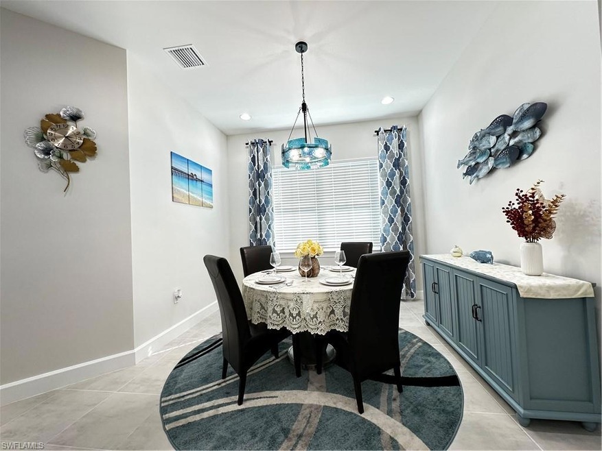 Dining area with a notable chandelier and light ti