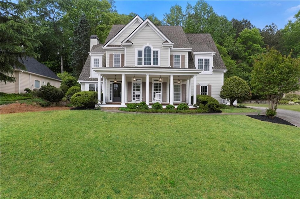 Colonial house with a front lawn, a chimney, and c