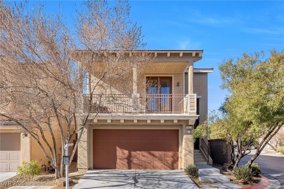 View of front of property with driveway, a balcony