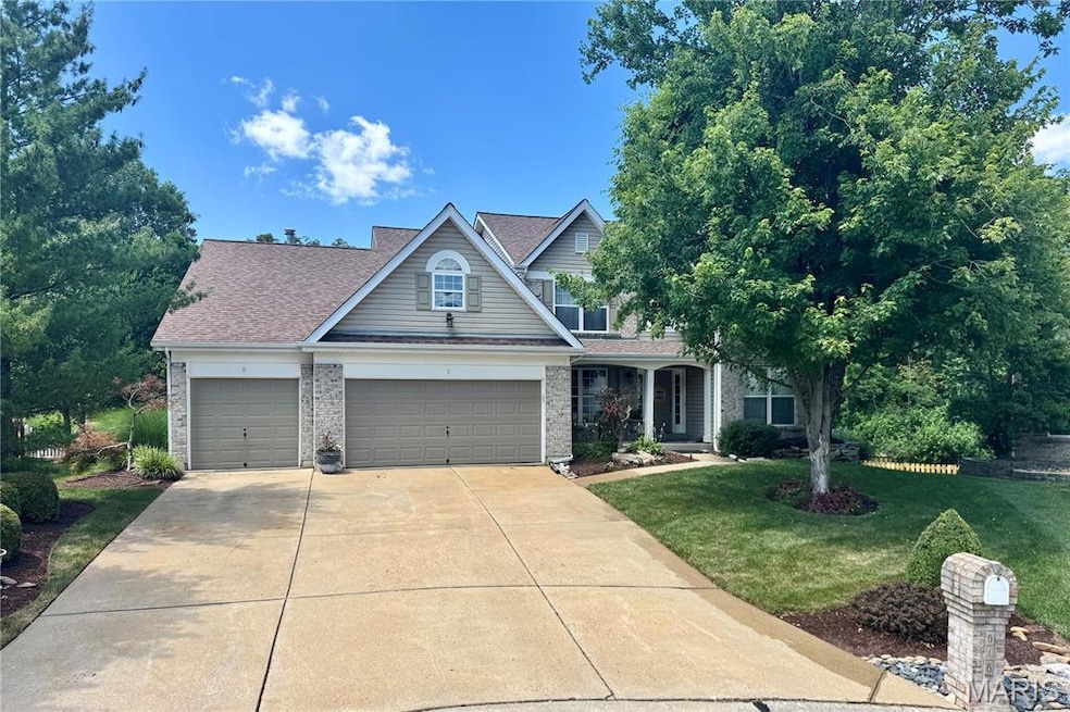 Traditional-style home with a front lawn, driveway, a garage, roof with shingles, and brick siding