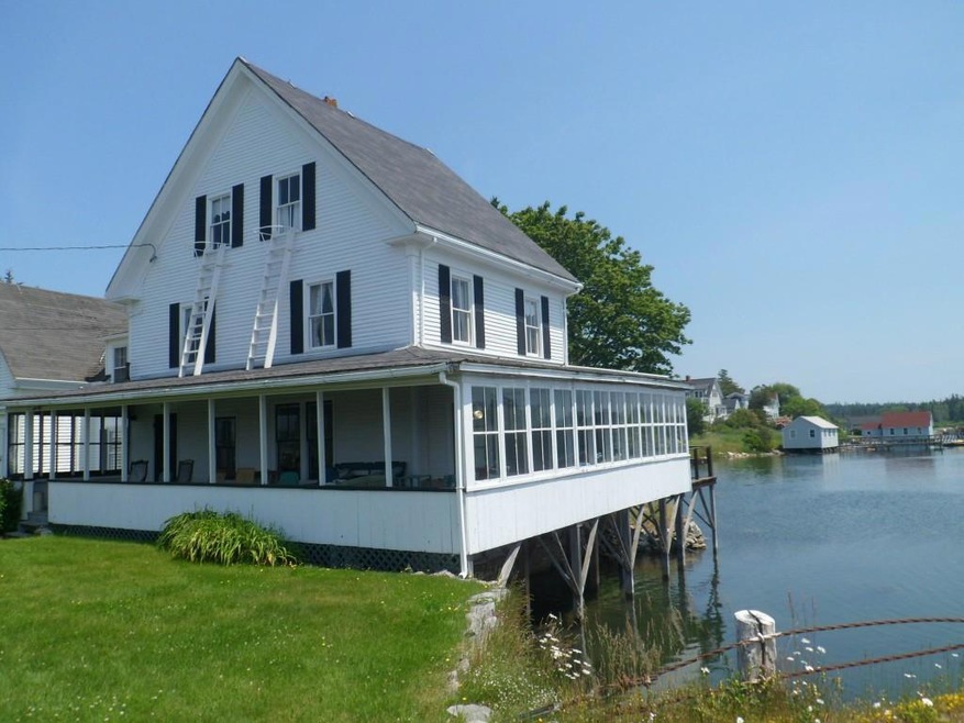 Charming exterior featuring covered...