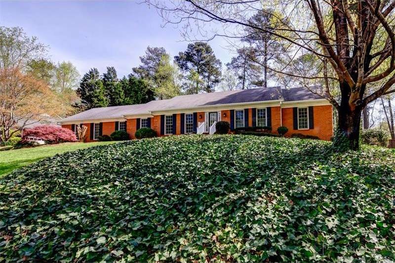 Large 4 sided brick sits on lovely lot.