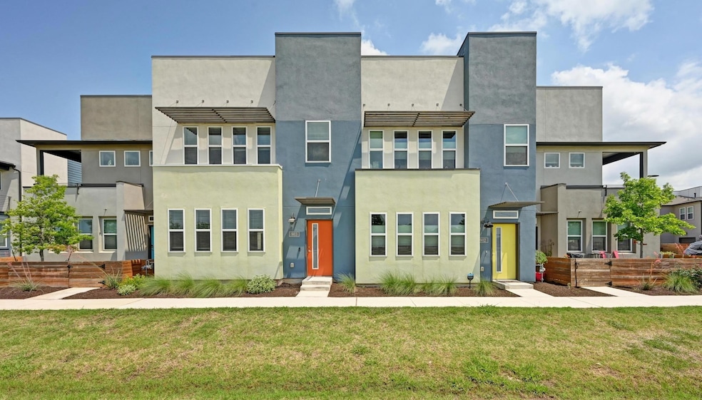 Townhome / multi-family property with a front lawn