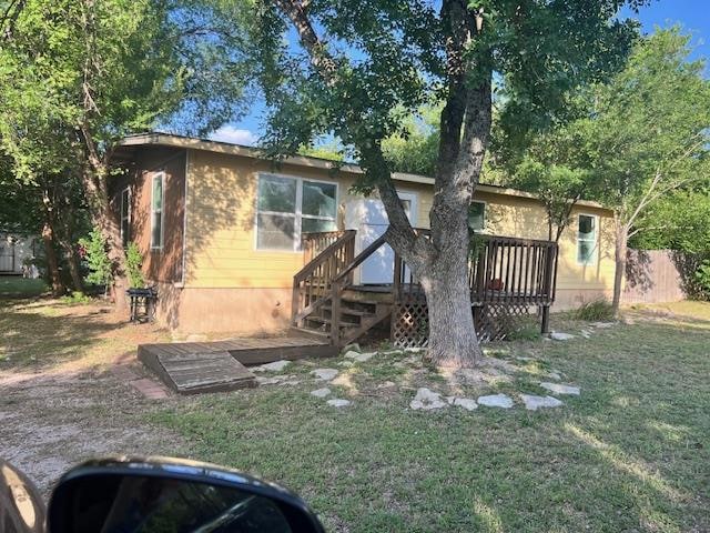 View of front of home featuring a wooden deck