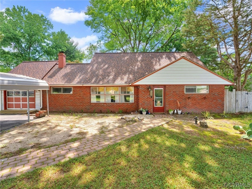 Rear view of property with a lawn