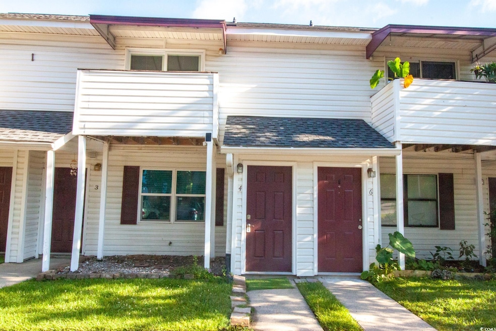 Townhome / multi-family property with a balcony and a shingled roof