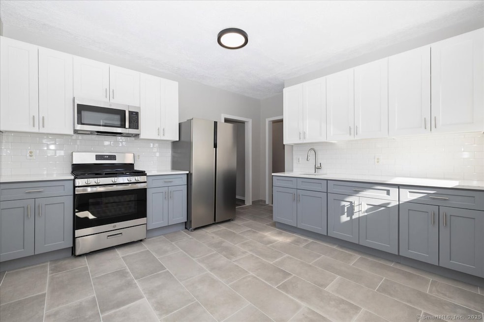 Large and brand new eat in kitchen, with quartz co