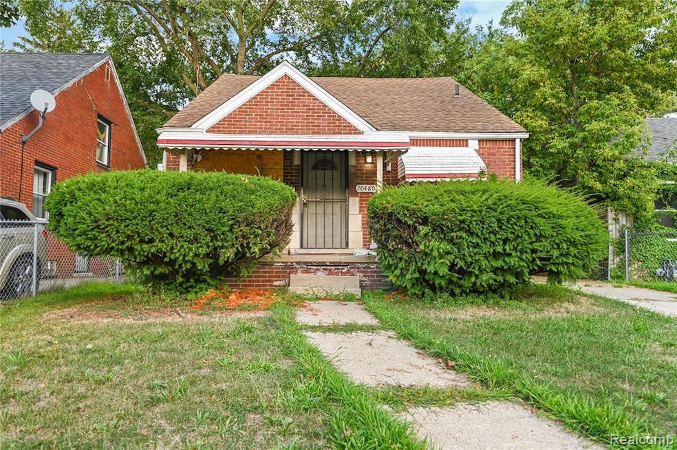 Bungalow featuring brick siding and a shingled roof