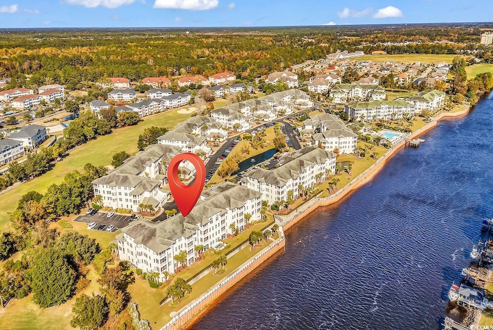 Aerial view of apartment complex and a nearby body of water