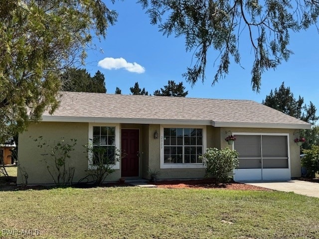 Ranch-style house featuring driveway, stucco sidin