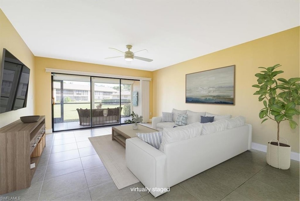 Living area featuring ceiling fan and baseboards