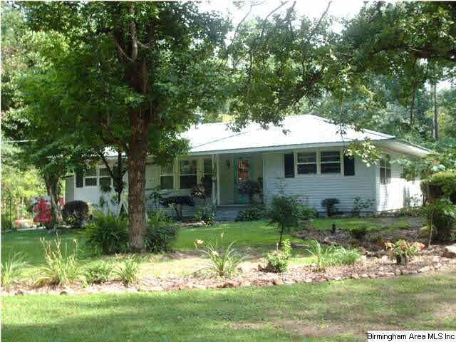 Front view of home showing the beautiful flowers a