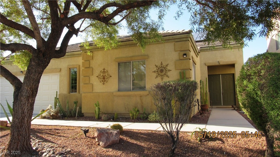 View of front of home featuring a garage and stucc