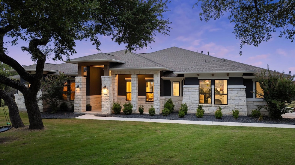 Prairie-style house featuring stone siding, roof 