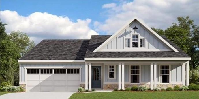 View of front of property with a garage, a porch, 