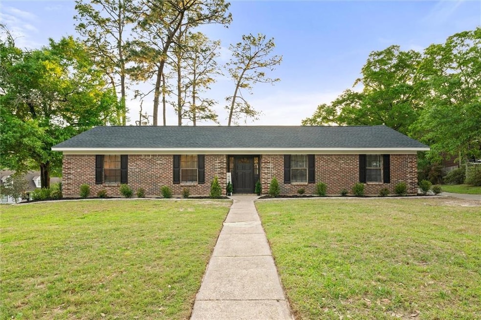 View of front of home with a front yard, brick sid
