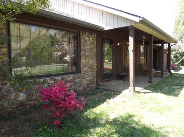 Gorgeous stone detail around large picture window of living room on this charming western cedar home on 5  acres.